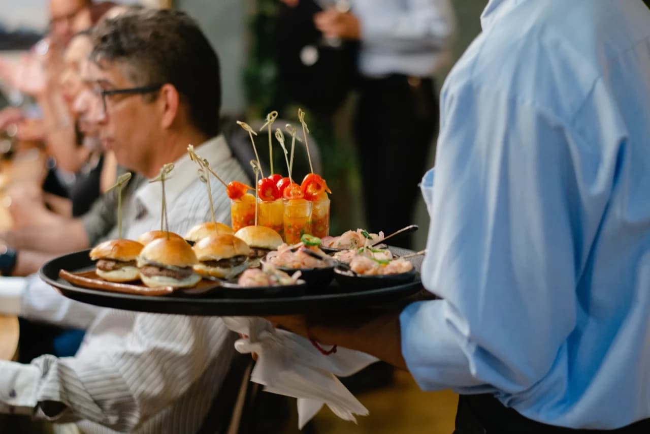 Caterer plating an elegant spread for an event