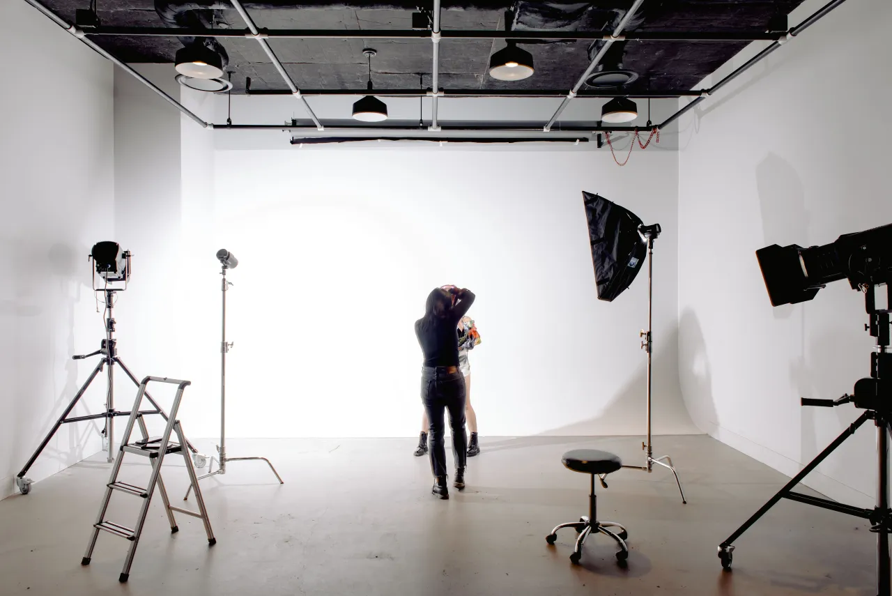 Photographer shooting a model on a white cyclorama